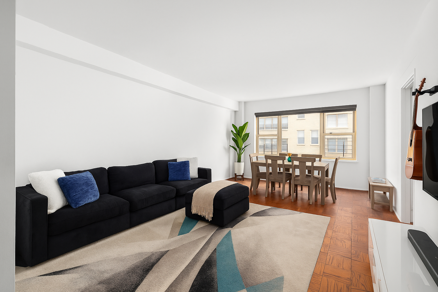 415 East 52nd Street, Unit 9AA Manhattan, NY 10022 - Photo 1 of 10 a living room with furniture a flat screen tv and a large window