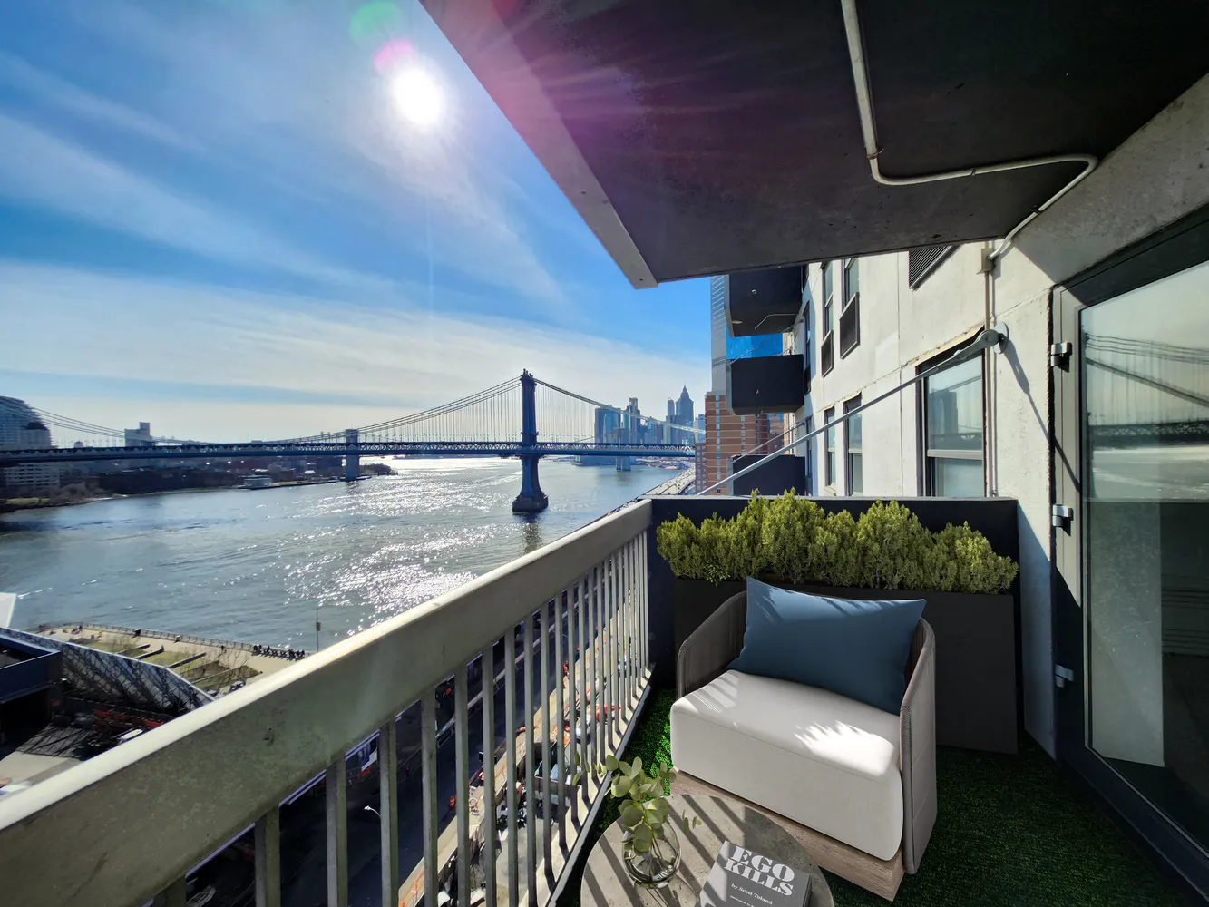 a balcony with wooden floor and outdoor seating