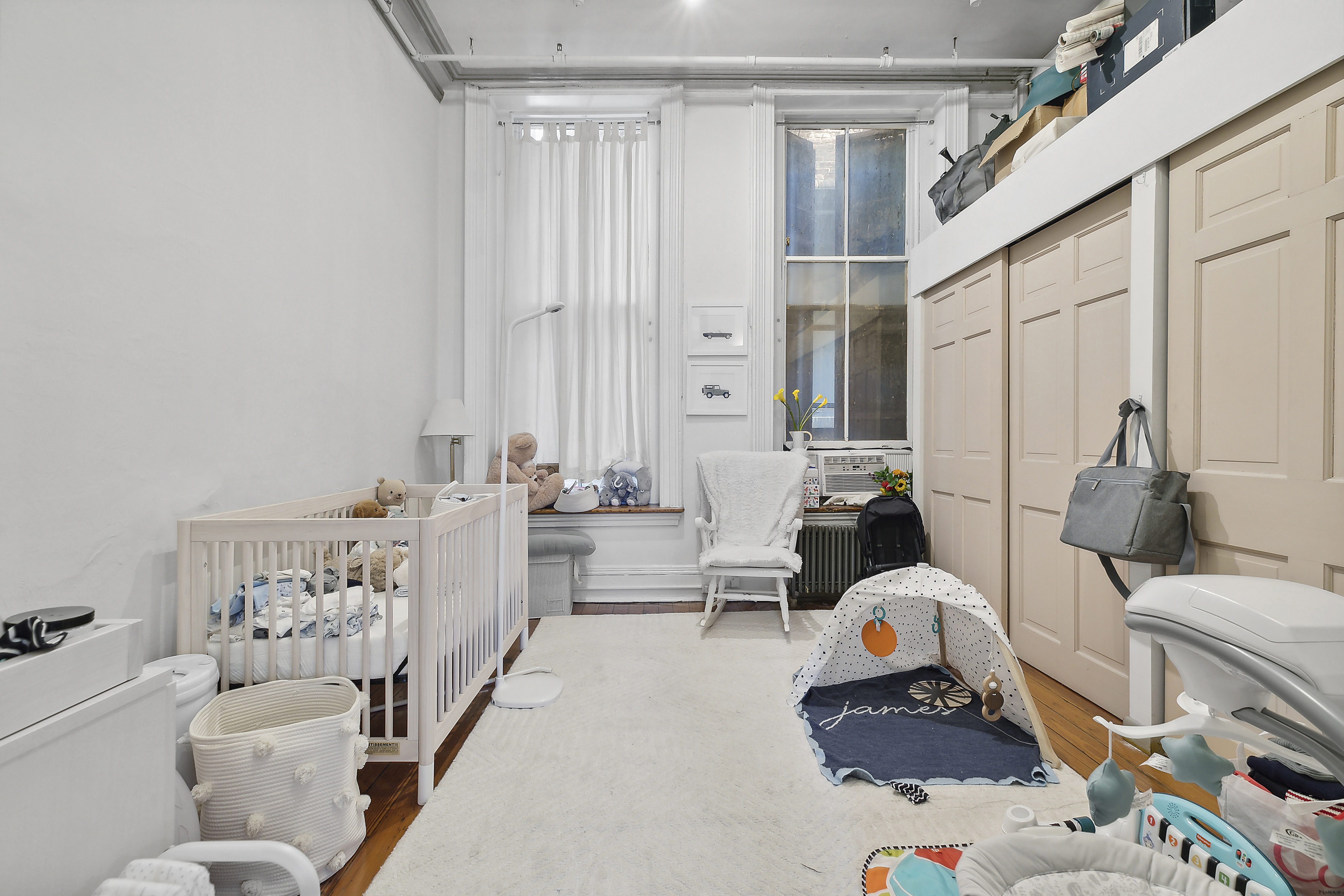 116 Franklin Street, Unit 3 Manhattan, NY 10013 - Photo 3 of 9 a living room with furniture and a large window