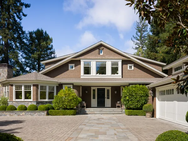 a front view of a house with a garden