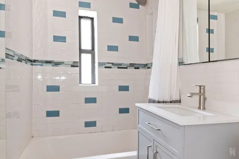 a bathroom with a bathtub and a sink