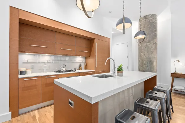 a kitchen that has a cabinets a sink and a stove