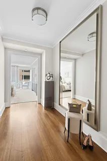 a view of a livingroom with wooden floor and furniture