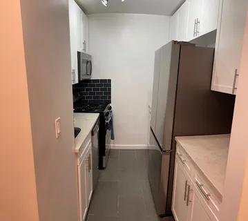 a kitchen with a refrigerator and a stove