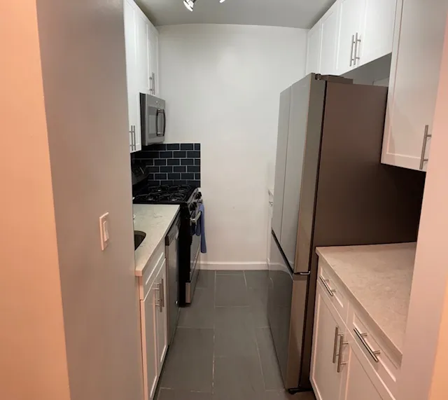 a kitchen with a refrigerator and a stove