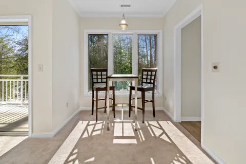 a view of a room with balcony and furniture