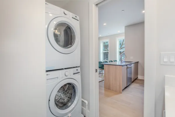 a view of a hallway with washer and dryer