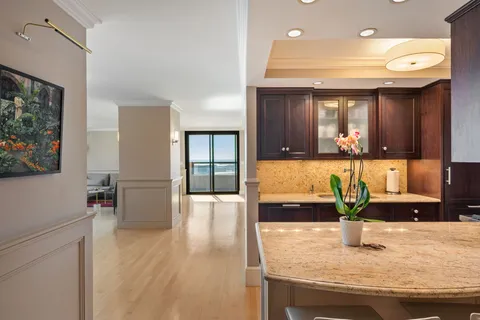 a view of kitchen with granite countertop window