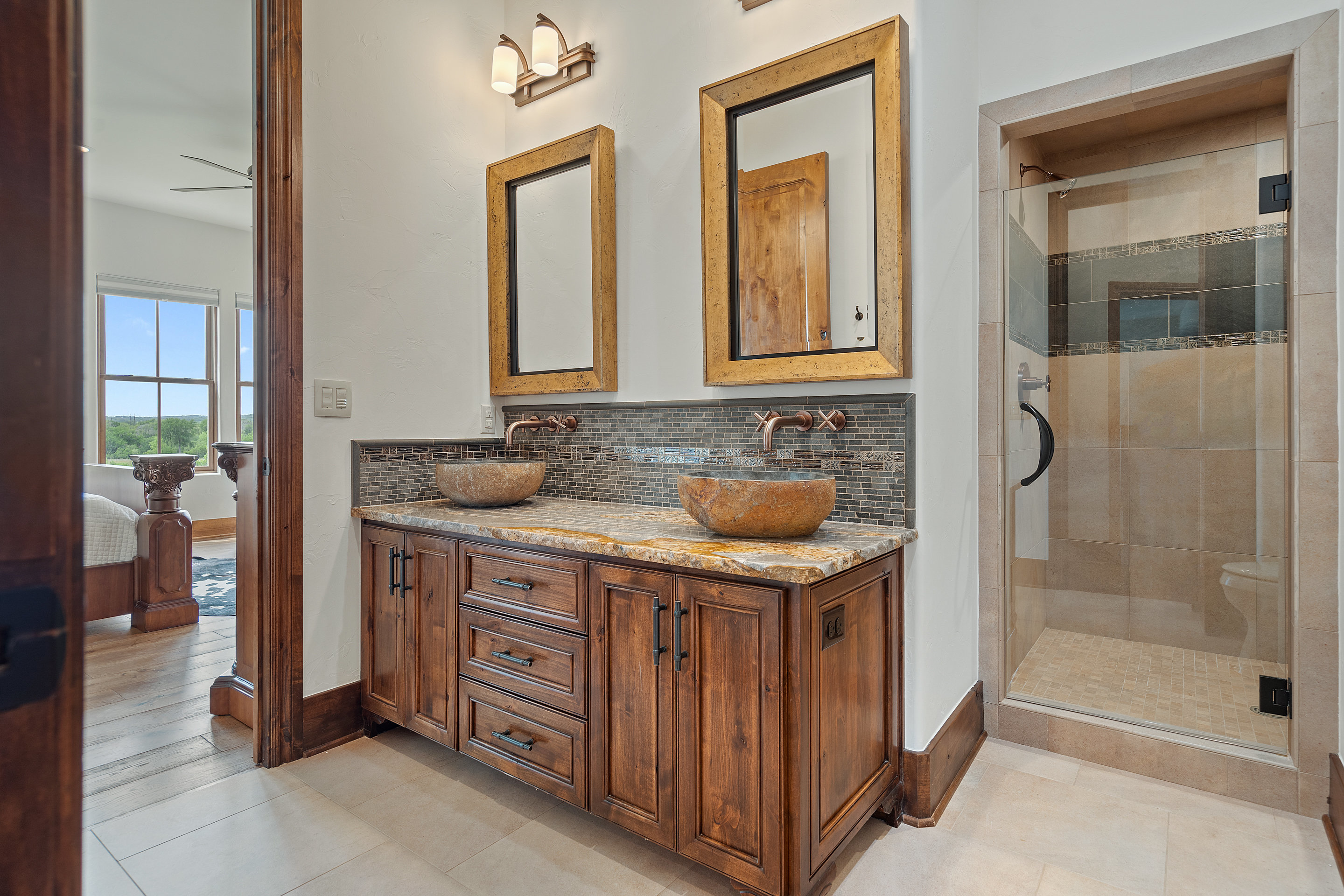 808 Rivercliff Drive Spicewood, TX 78669 - Photo 45 of 71 a bathroom with a granite countertop sink a mirror and shower