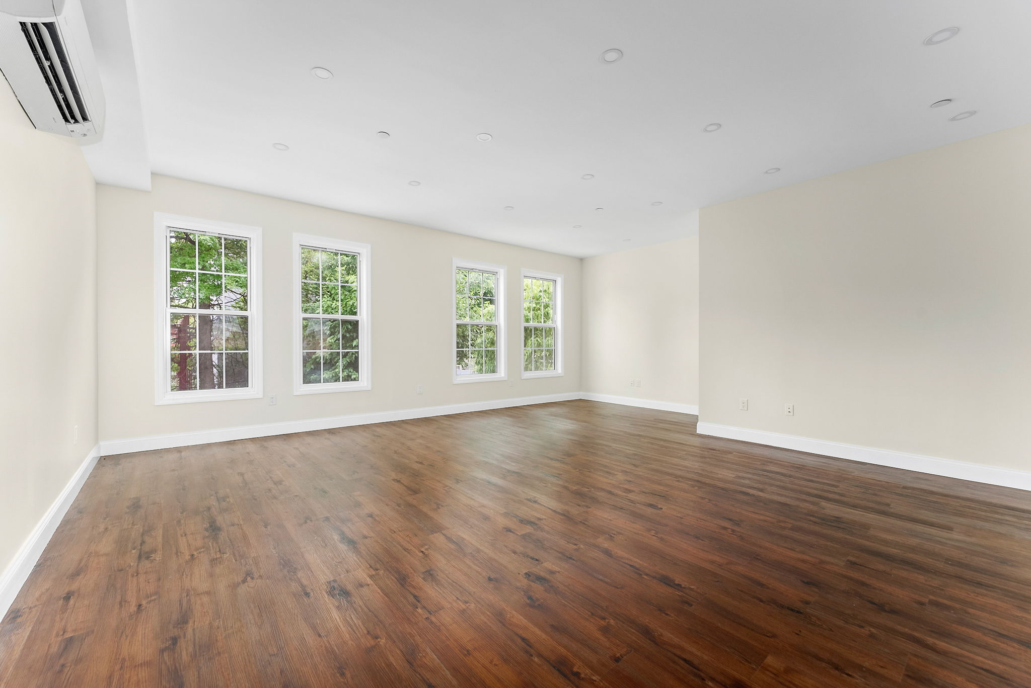 217 Butler Street, Unit 2 Brooklyn, NY 11217 - Photo 3 of 15 an empty room with wooden floor and windows
