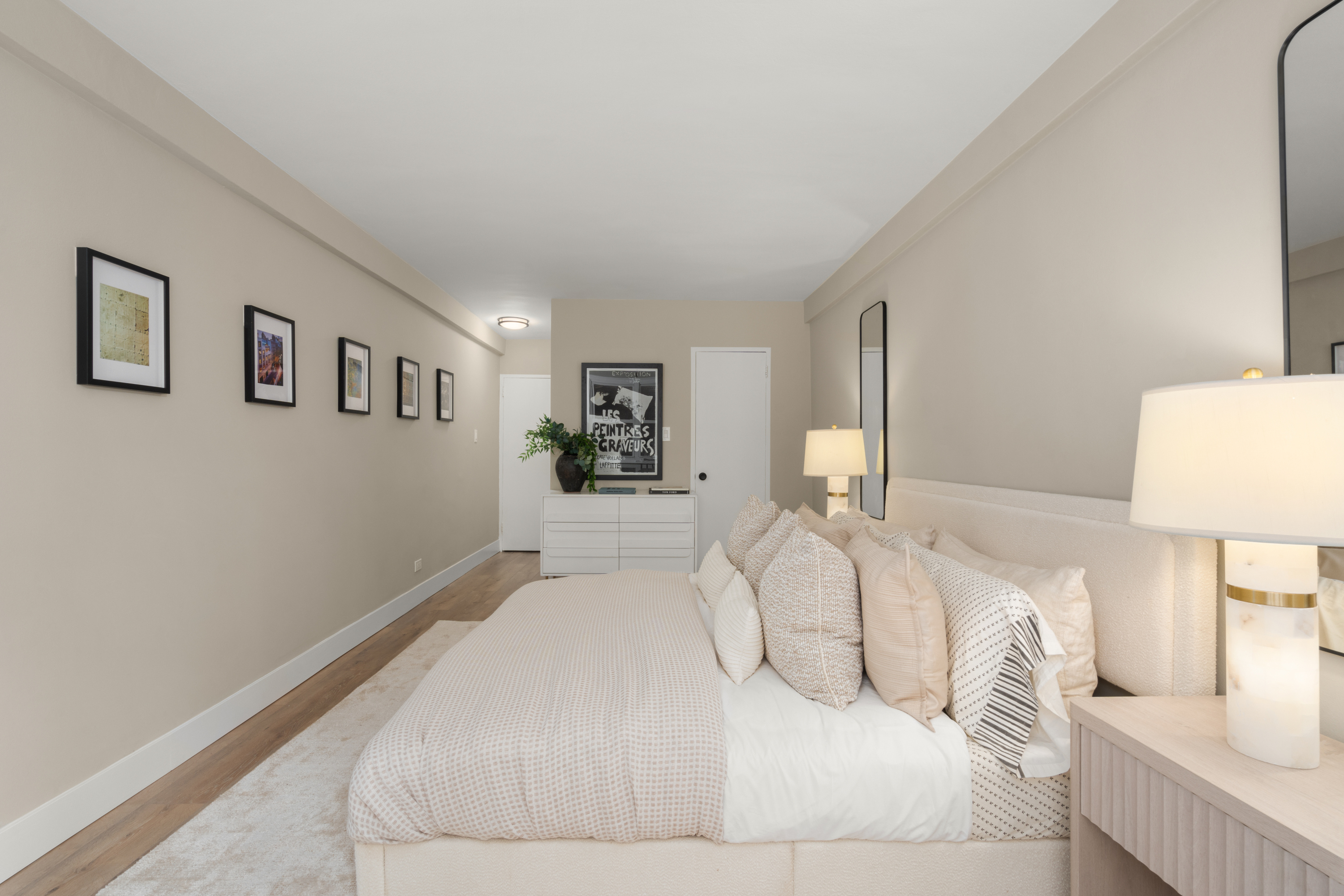 347 East 53rd Street, Unit 2C Manhattan, NY 10022 - Photo 12 of 18 a large white bed in a white room