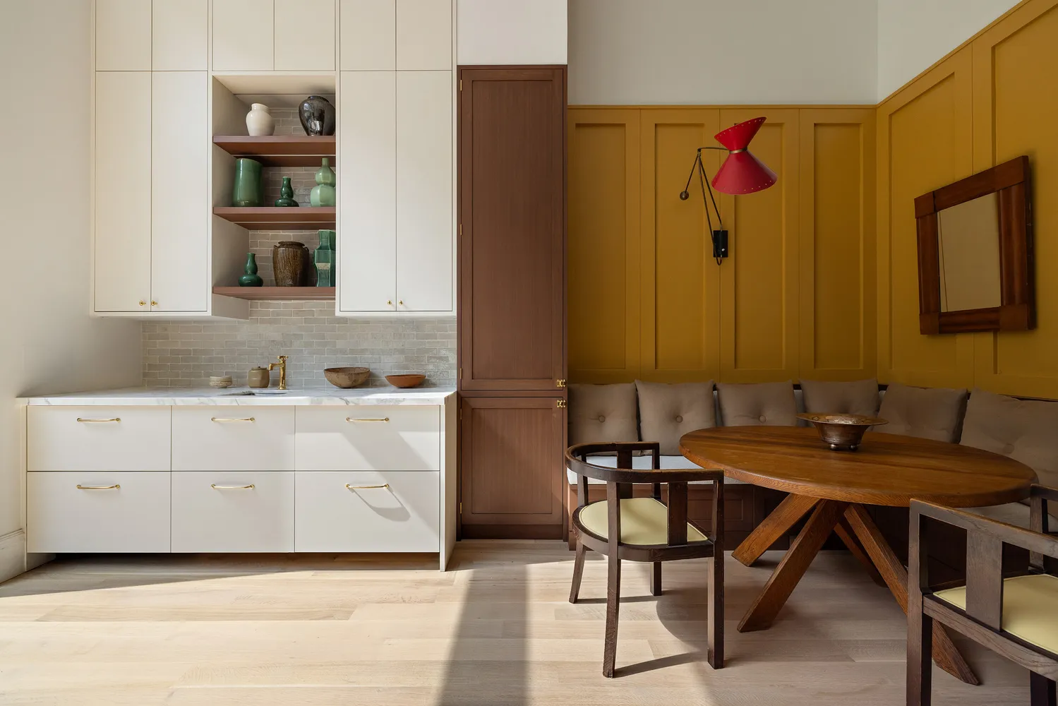 a kitchen with a table chairs and a refrigerator