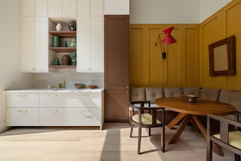 a kitchen with a table chairs and a refrigerator