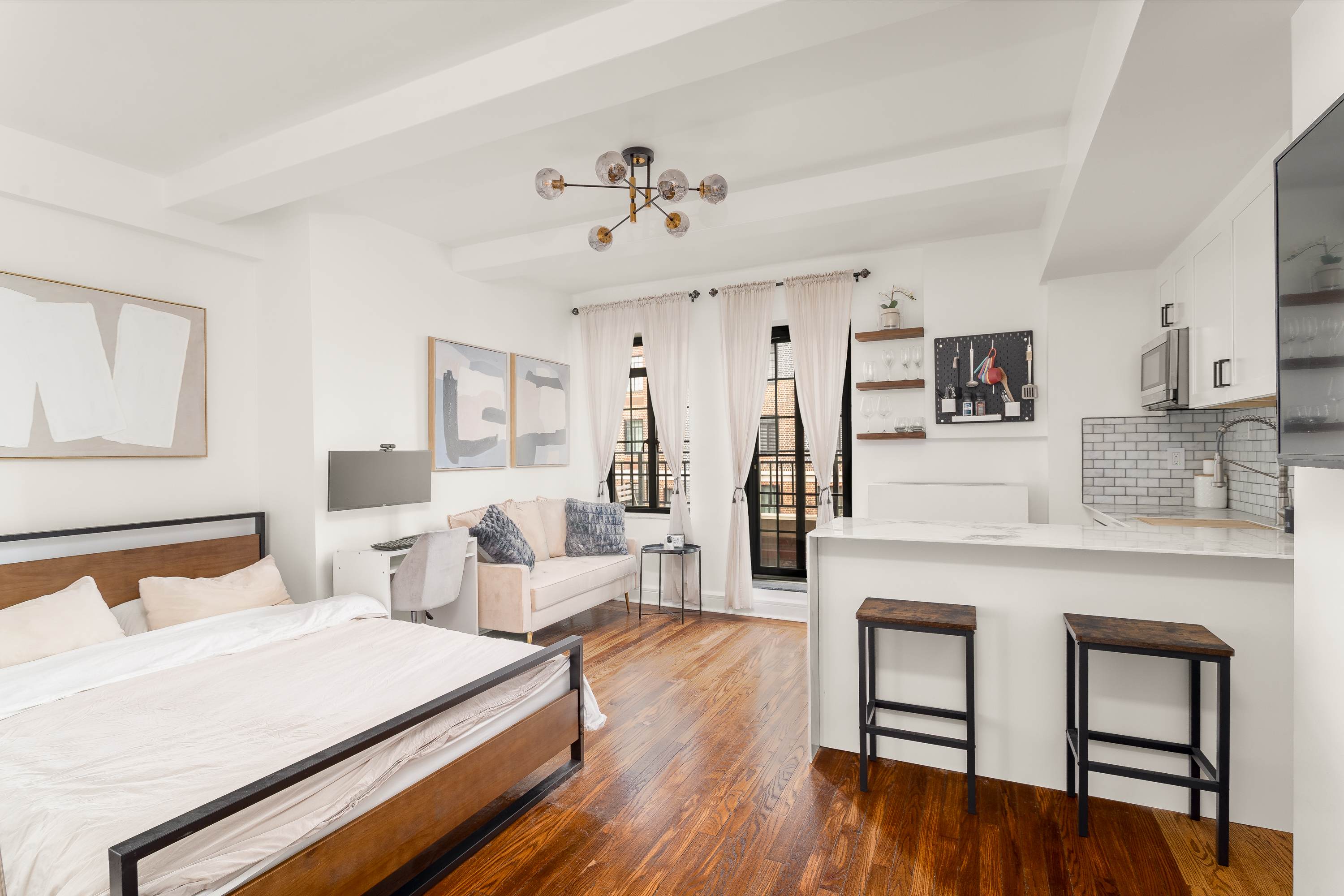 a spacious bedroom with a bed and a chandelier