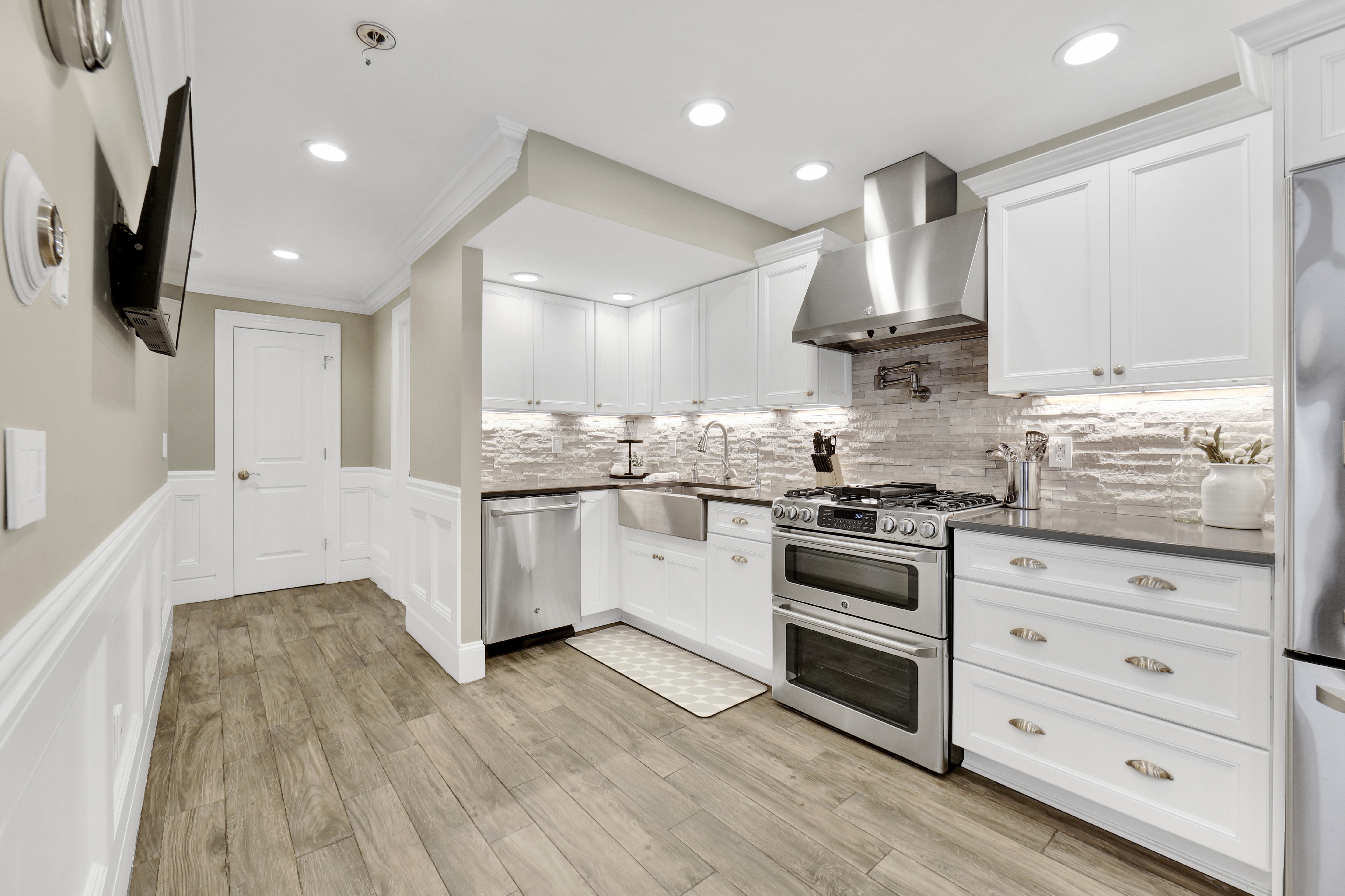 1-69 Beach 98th Street, Unit 1 Queens, NY 11694 - Photo 9 of 23 a kitchen with stainless steel appliances kitchen island granite countertop a stove a sink and a refrigerator