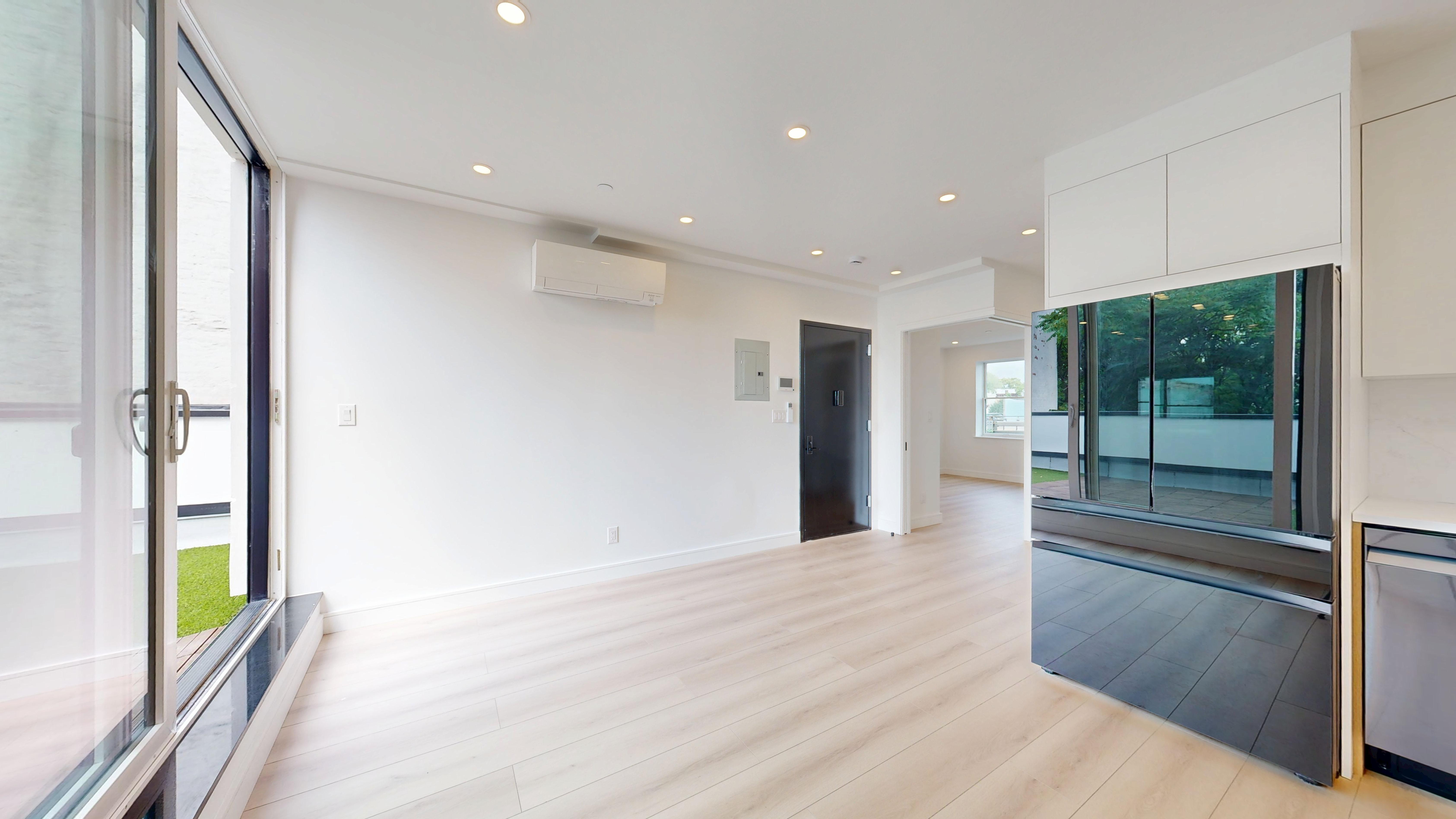 5614 3rd Avenue, Unit 3 Brooklyn, NY 11220 - Photo 8 of 11 a view of a hallway with wooden floor and glass door