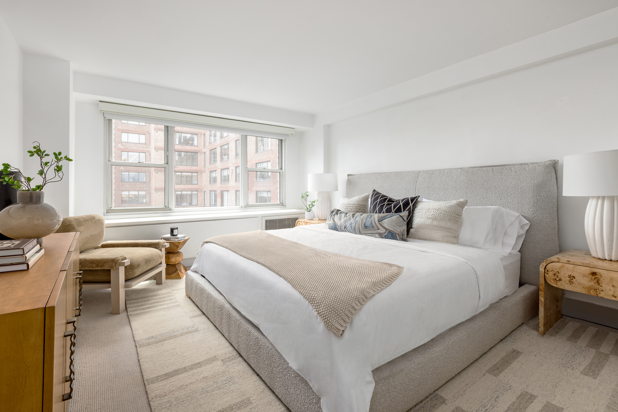2 Charlton Street, Unit 11LM Manhattan, NY 10014 - Photo 8 of 16 a bedroom with a bed and a couch