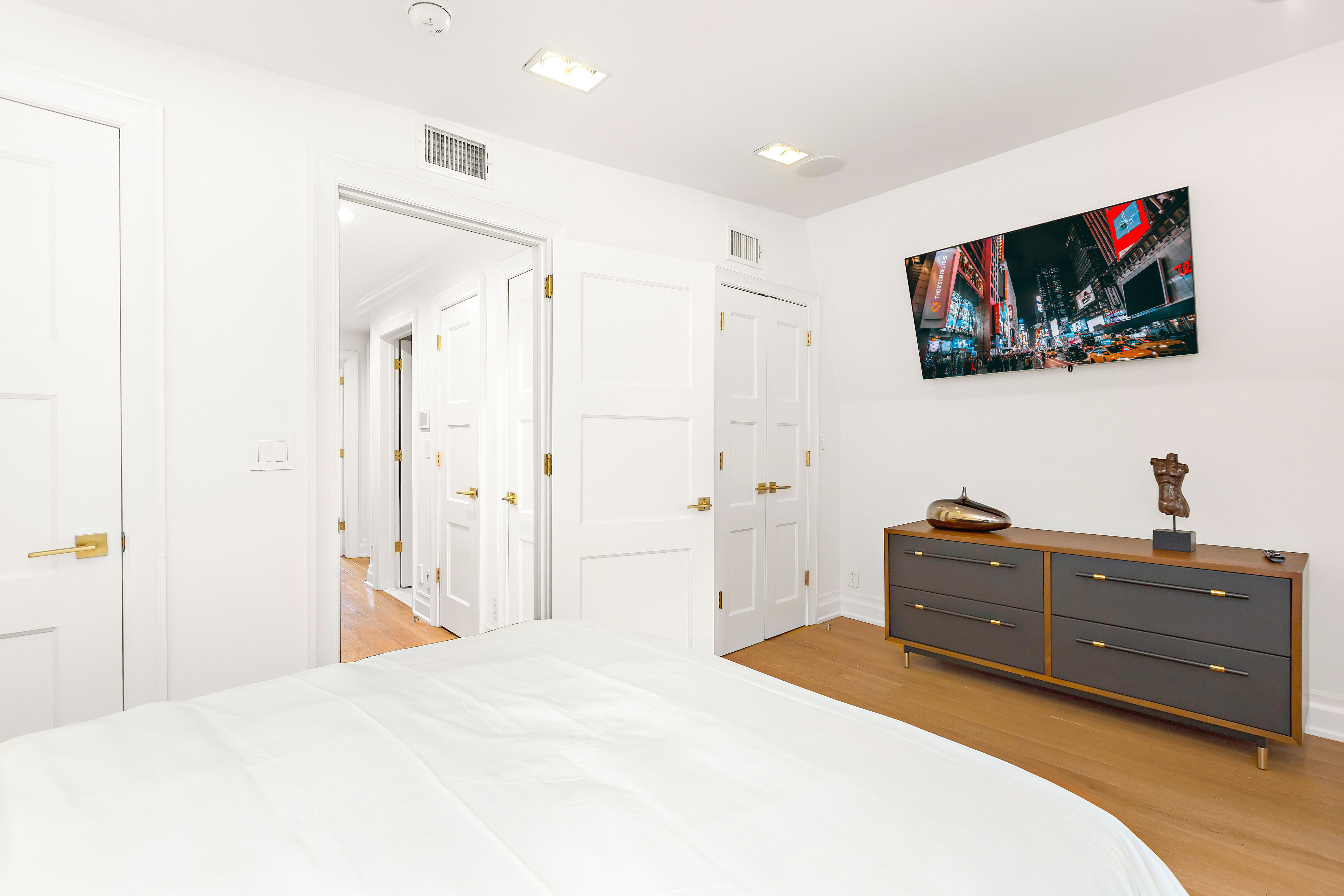 134 East 36th Street Manhattan, NY 10016 - Photo 8 of 28 a bedroom with a bed and a flat screen tv