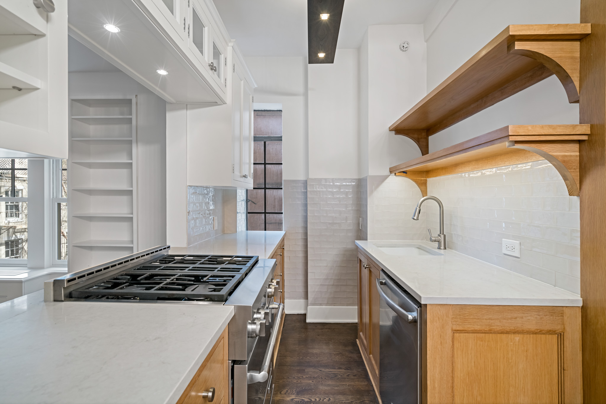 299 West 12th Street, Unit 3JH Manhattan, NY 10014 - Photo 5 of 15 a kitchen with a sink a stove and cabinets