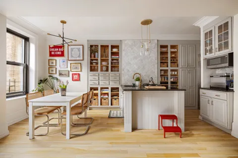 a room with a workspace and a window