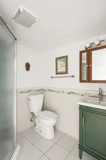 a bathroom with a toilet sink and mirror
