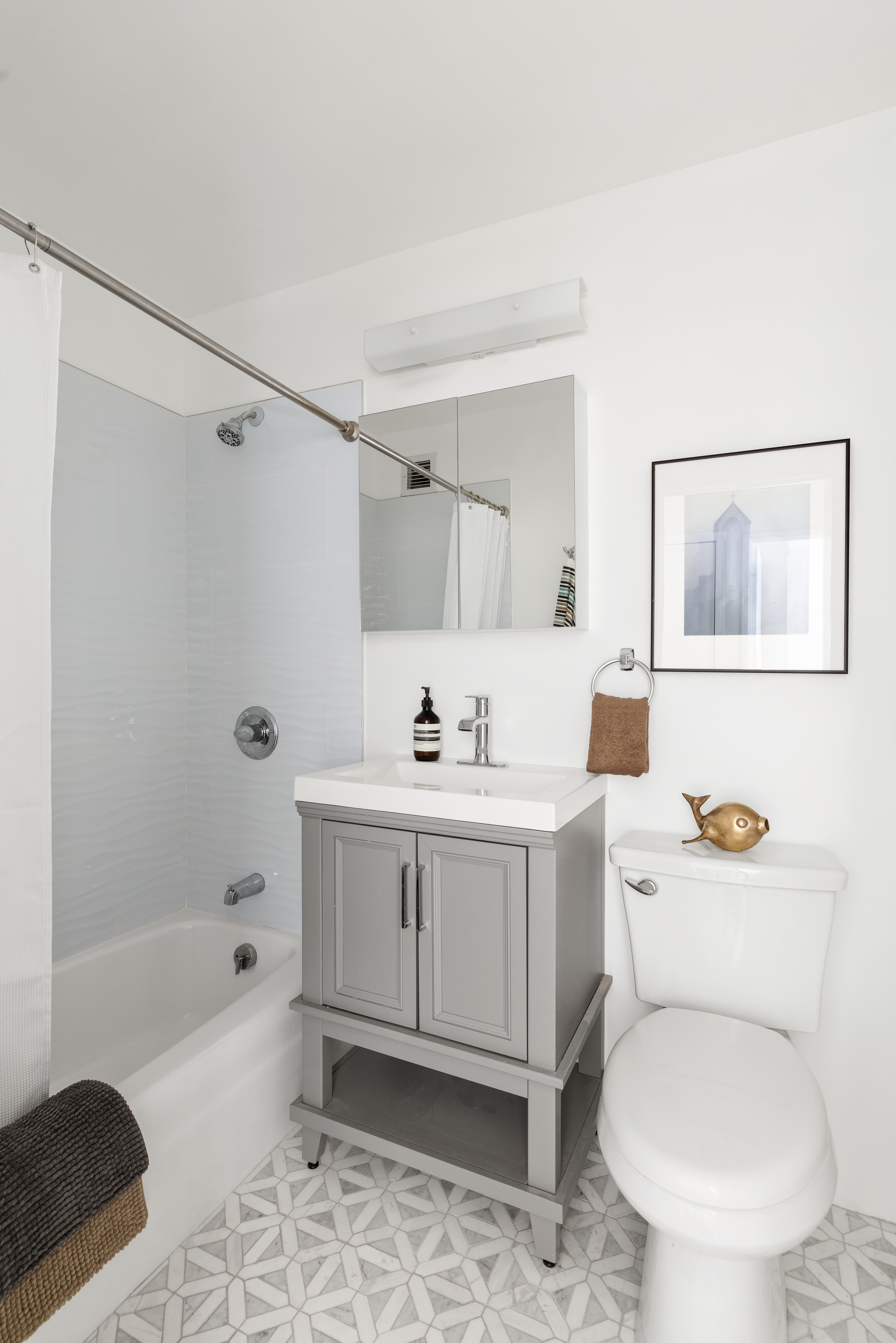 141 Barrow Street, Unit 1B Manhattan, NY 10014 - Photo 7 of 10 a bathroom with a sink toilet a shower and bathtub