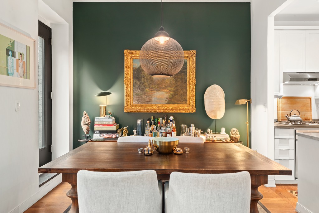 422 West 20th Street, Unit PARLOR H Manhattan, NY 10011 - Photo 4 of 16 a room with a table chairs and a wooden floor