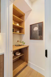 a room with a wooden floor and cabinets