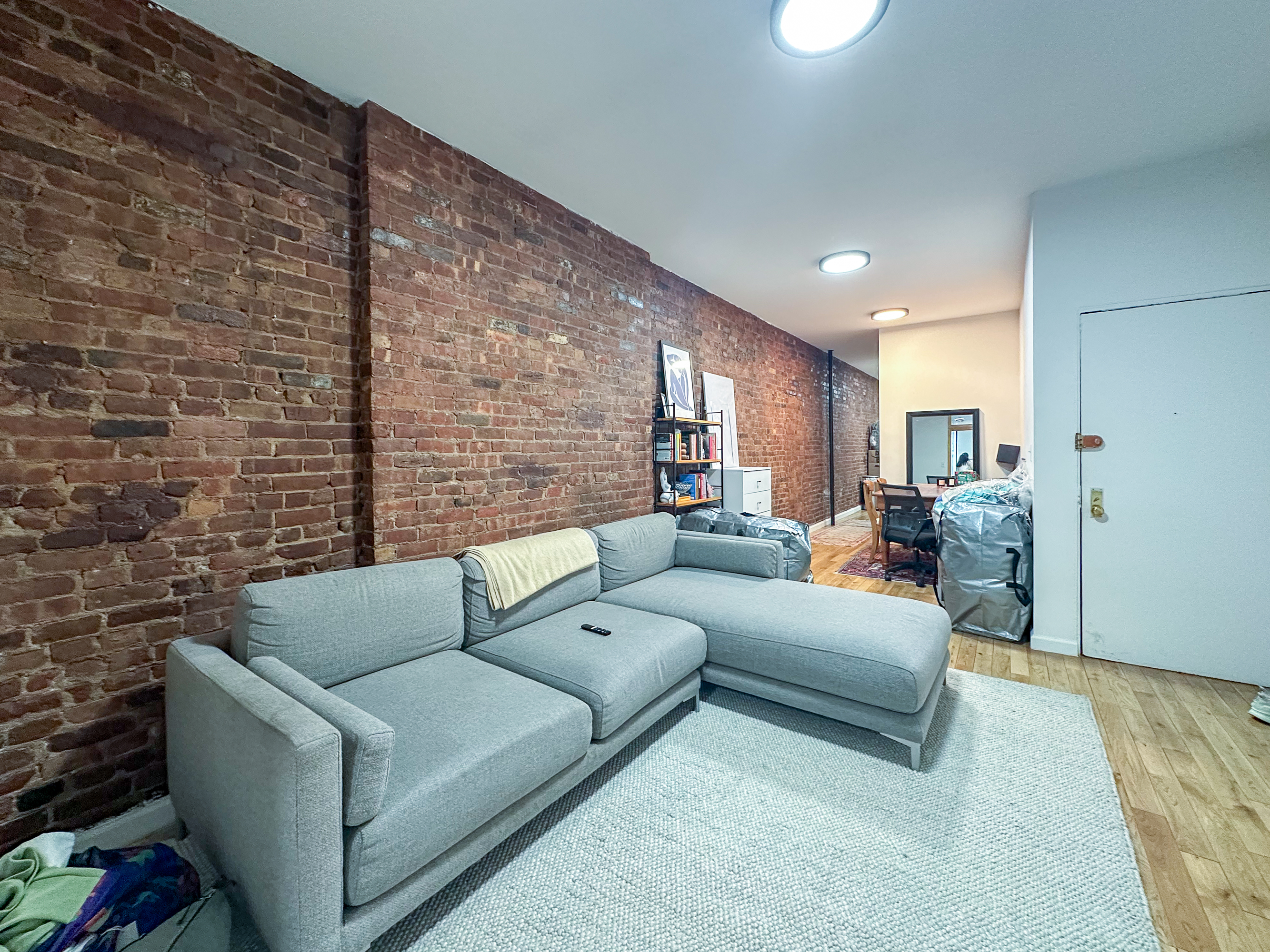 215 East 5th Street, Unit 7 Manhattan, NY 10003 - Photo 5 of 15 a living room with furniture