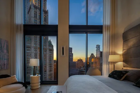 a bedroom with a bed and glass door