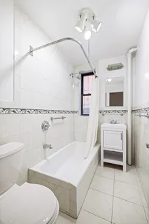 a bathroom with a sink a toilet and bathtub