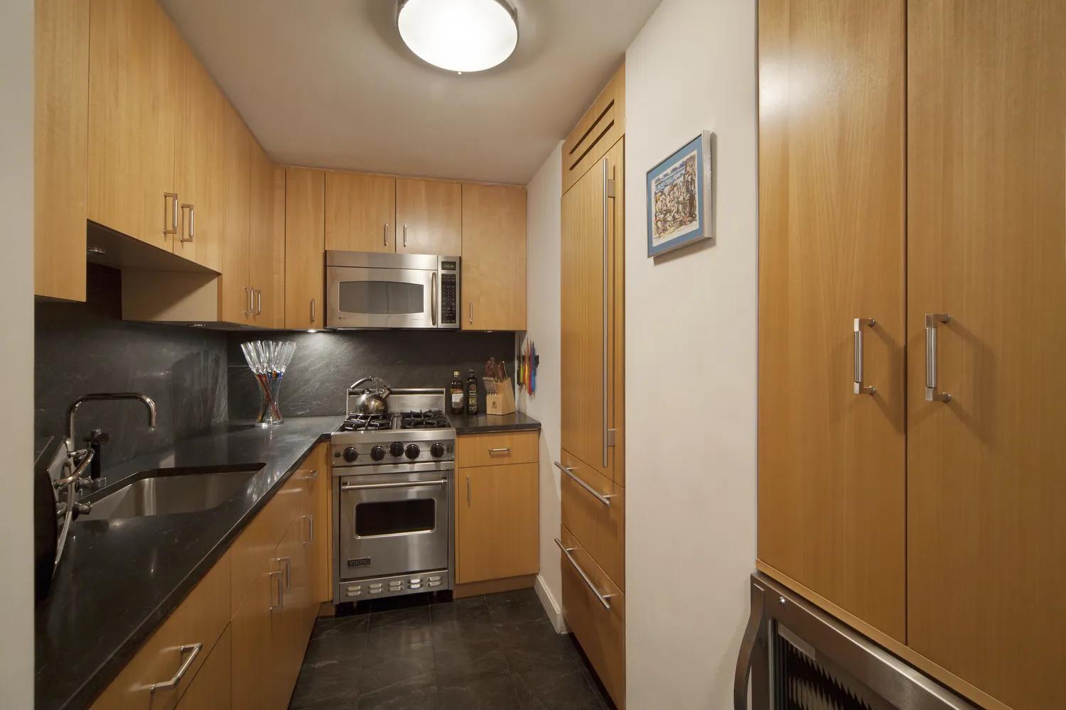 a kitchen with a sink and stainless steel appliances