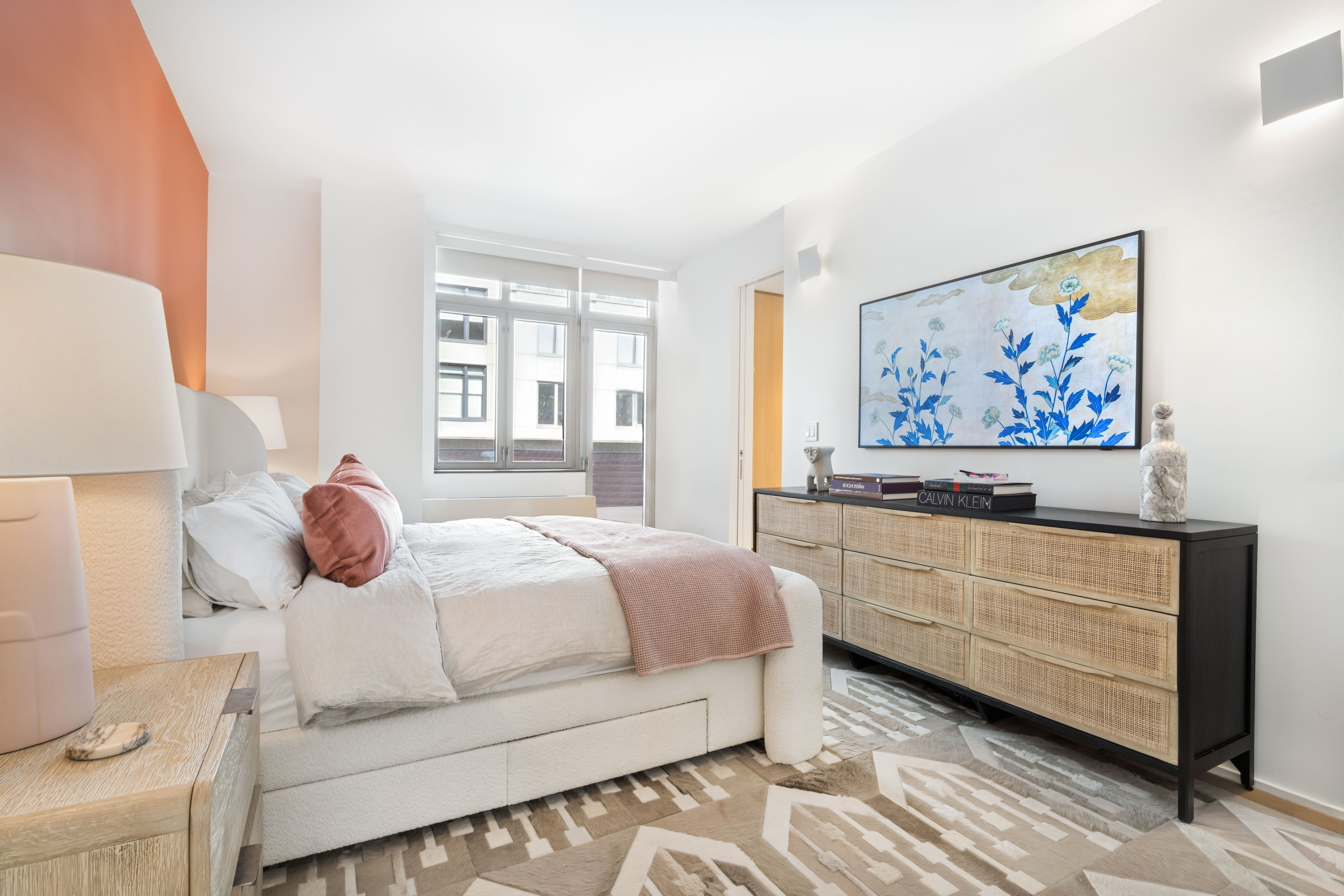 125 West 22nd Street, Unit 10A Manhattan, NY 10011 - Photo 7 of 11 a bedroom with a bed and a painting on the wall