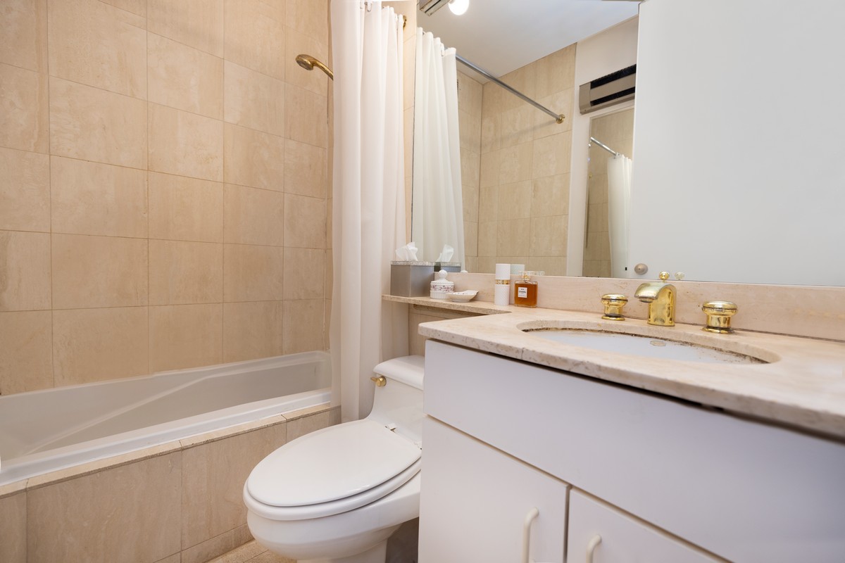 250 West 89th Street, Unit 5A Manhattan, NY 10024 - Photo 4 of 8 a bathroom with a granite countertop sink a toilet and shower