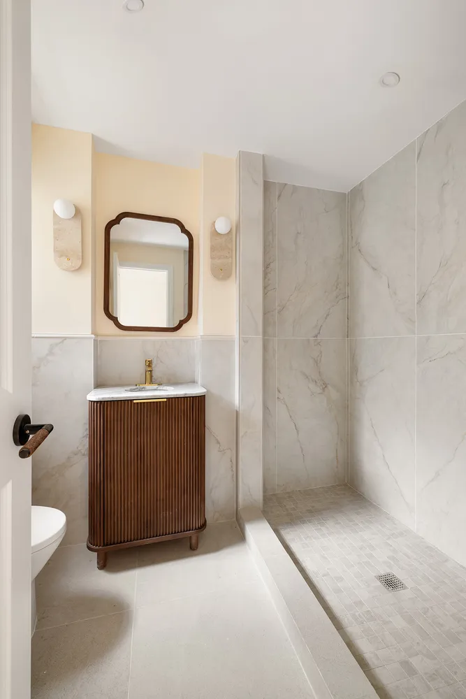 a bathroom with a sink a toilet and mirror