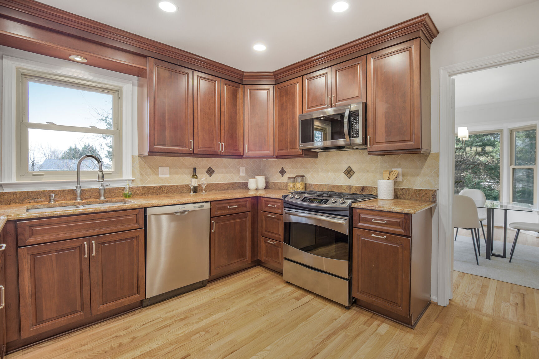 4008 Evangeline Terrace Olney, MD 20832 - Photo 22 of 54 a kitchen with stainless steel appliances granite countertop a stove a sink and a microwave