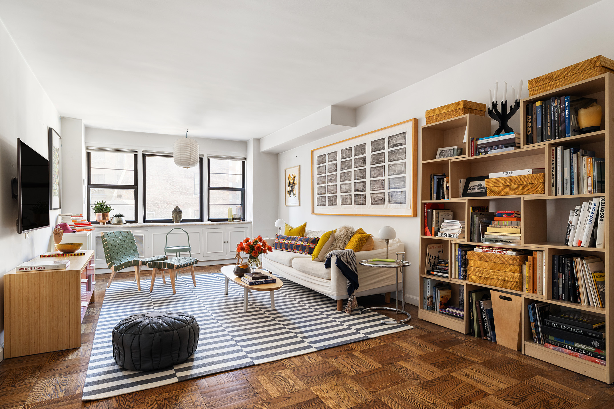 39 Gramercy Park North, Unit 9A Manhattan, NY 10010 - Photo 2 of 10 a living room with furniture a bookshelf and a window