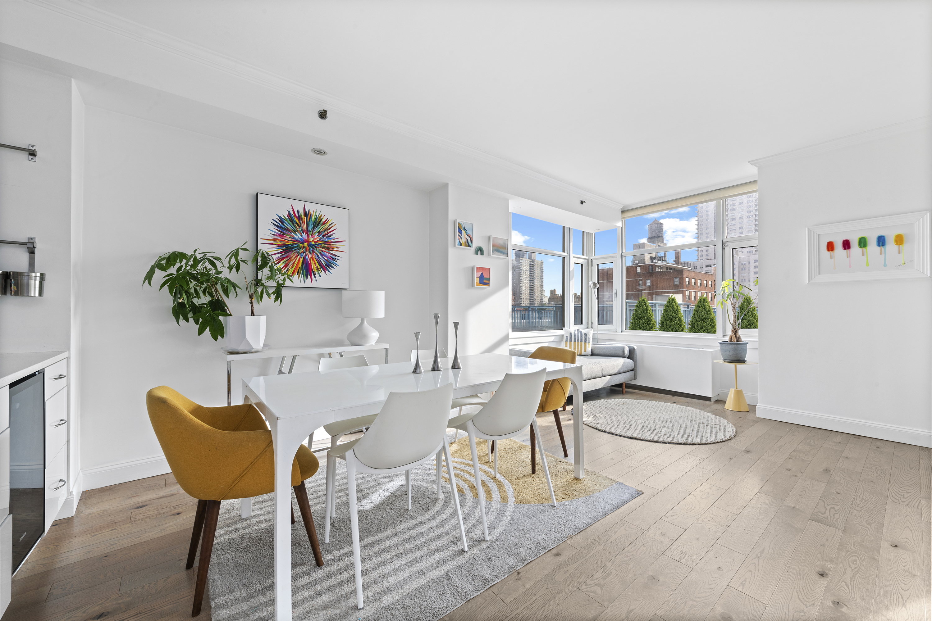 404 East 76th Street, Unit 8A Manhattan, NY 10021 - Photo 2 of 17 a living room with furniture and a potted plant