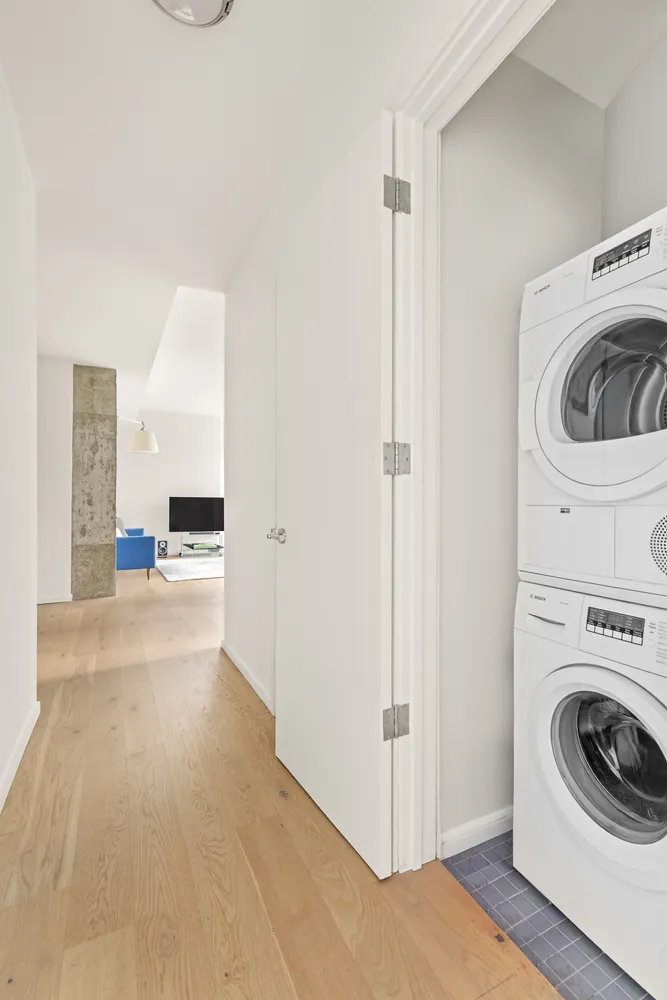 a view of a hallway with washer and dryer