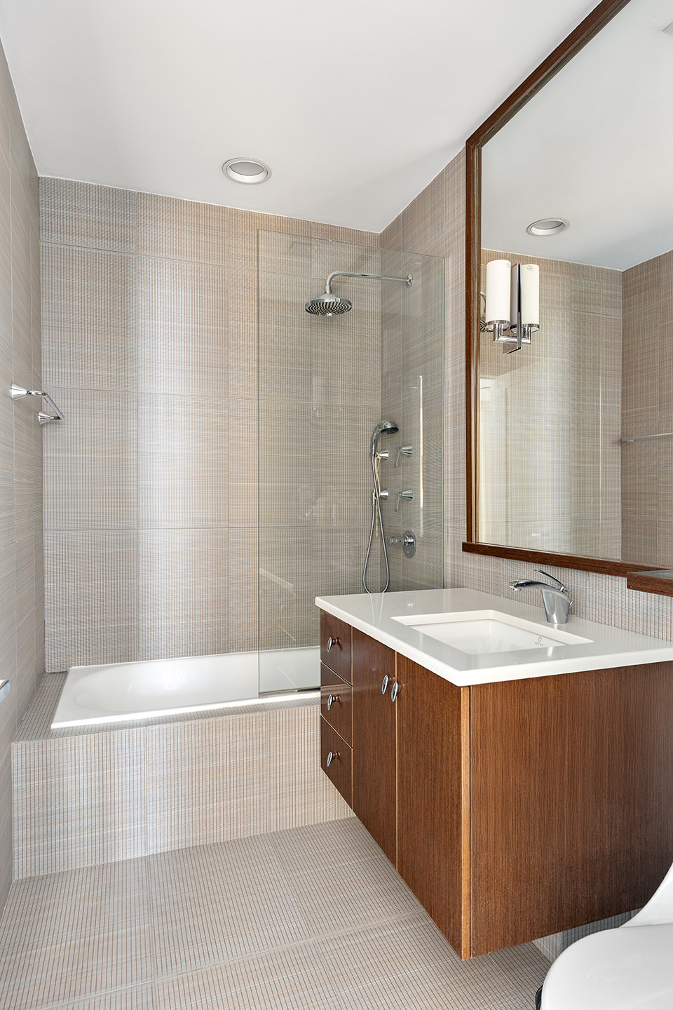 889 Broadway, Unit PHA Manhattan, NY 10003 - Photo 8 of 11 a spacious bathroom with a granite countertop tub sink and mirror