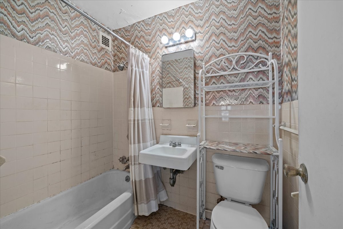 448 Neptune Avenue, Unit 16K Brooklyn, NY 11224 - Photo 8 of 28 a bathroom with a sink toilet and shower
