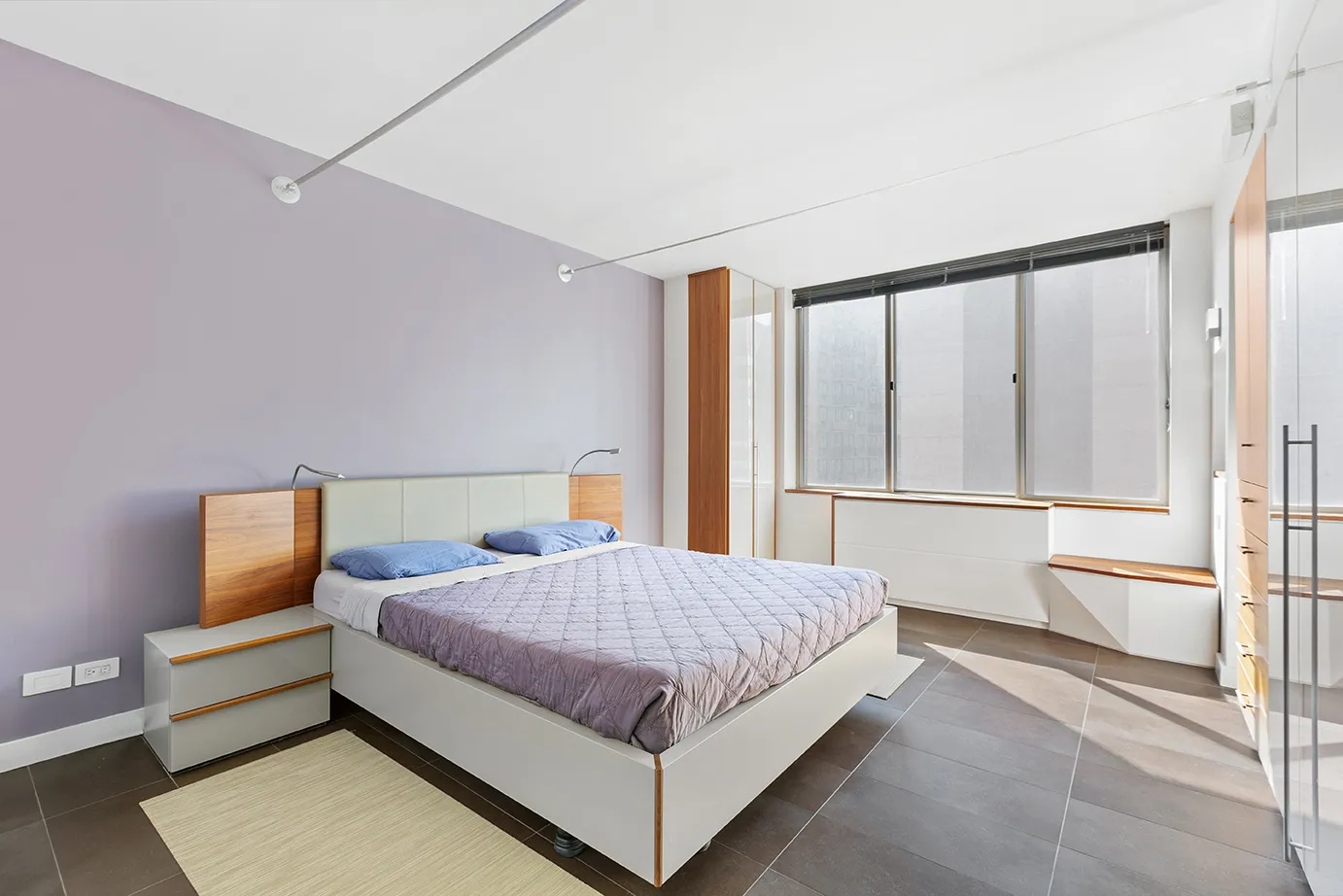 236 East 47th Street, Unit 27DE Manhattan, NY 10017 - Photo 4 of 16 a bedroom with a bed and wooden floor