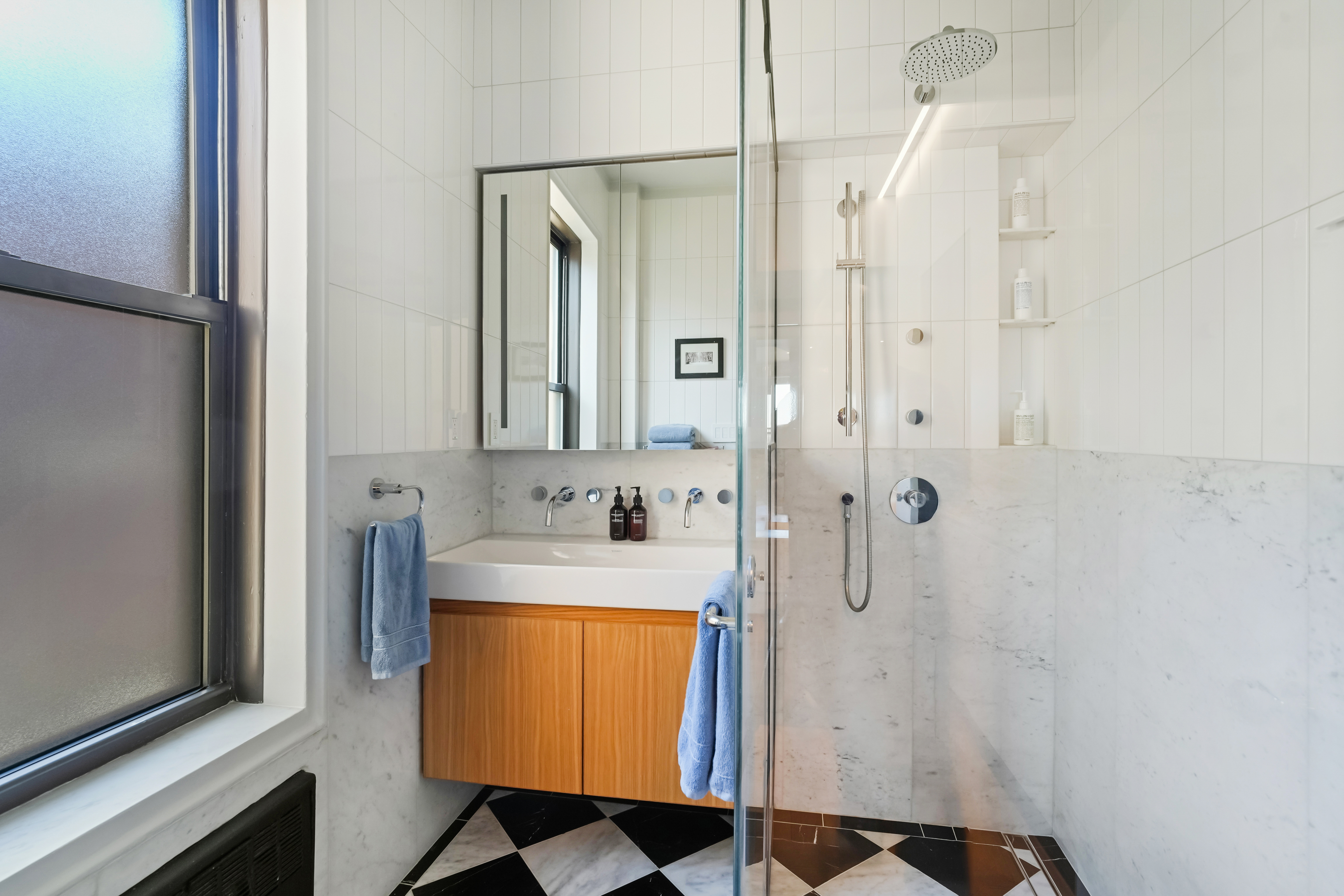 265 Riverside Drive, Unit 11F Manhattan, NY 10025 - Photo 13 of 18 a bathroom with a sink a mirror and shower