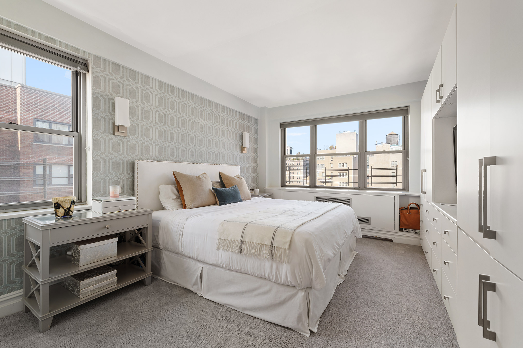 136 East 76th Street, Unit 16DE Manhattan, NY 10021 - Photo 7 of 14 a spacious bedroom with a bed and a large window