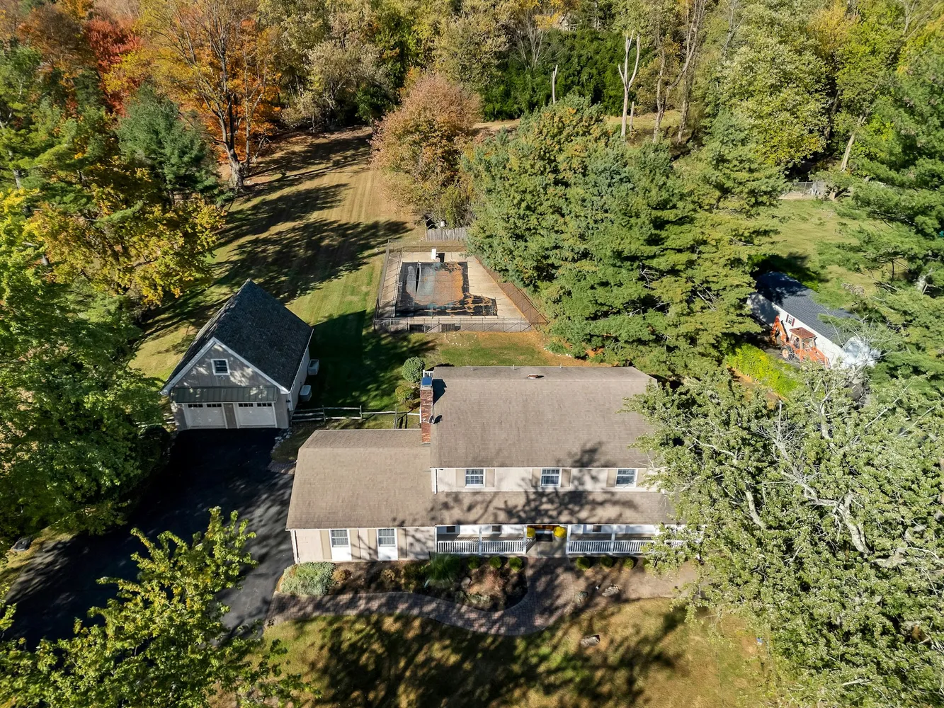 a view of a roof deck with table and chairs with wooden floor and fence
