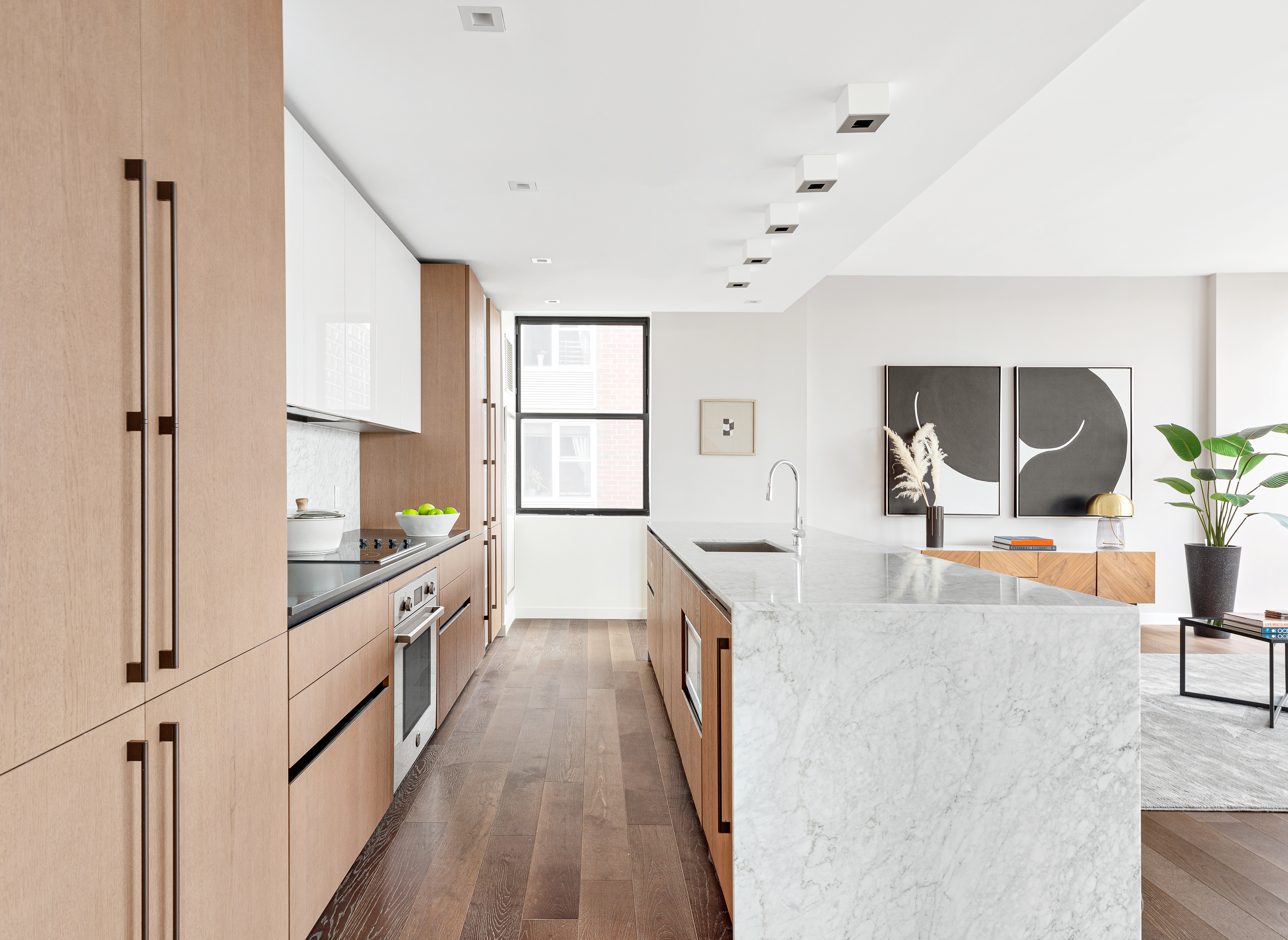 302 East 96th Street, Unit PH6 Manhattan, NY 10128 - Photo 4 of 13 a kitchen with granite countertop a stove and a wooden floors