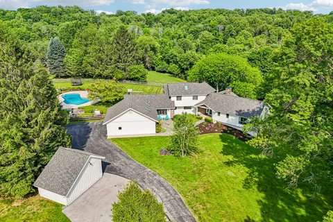 an aerial view of a house with a yard