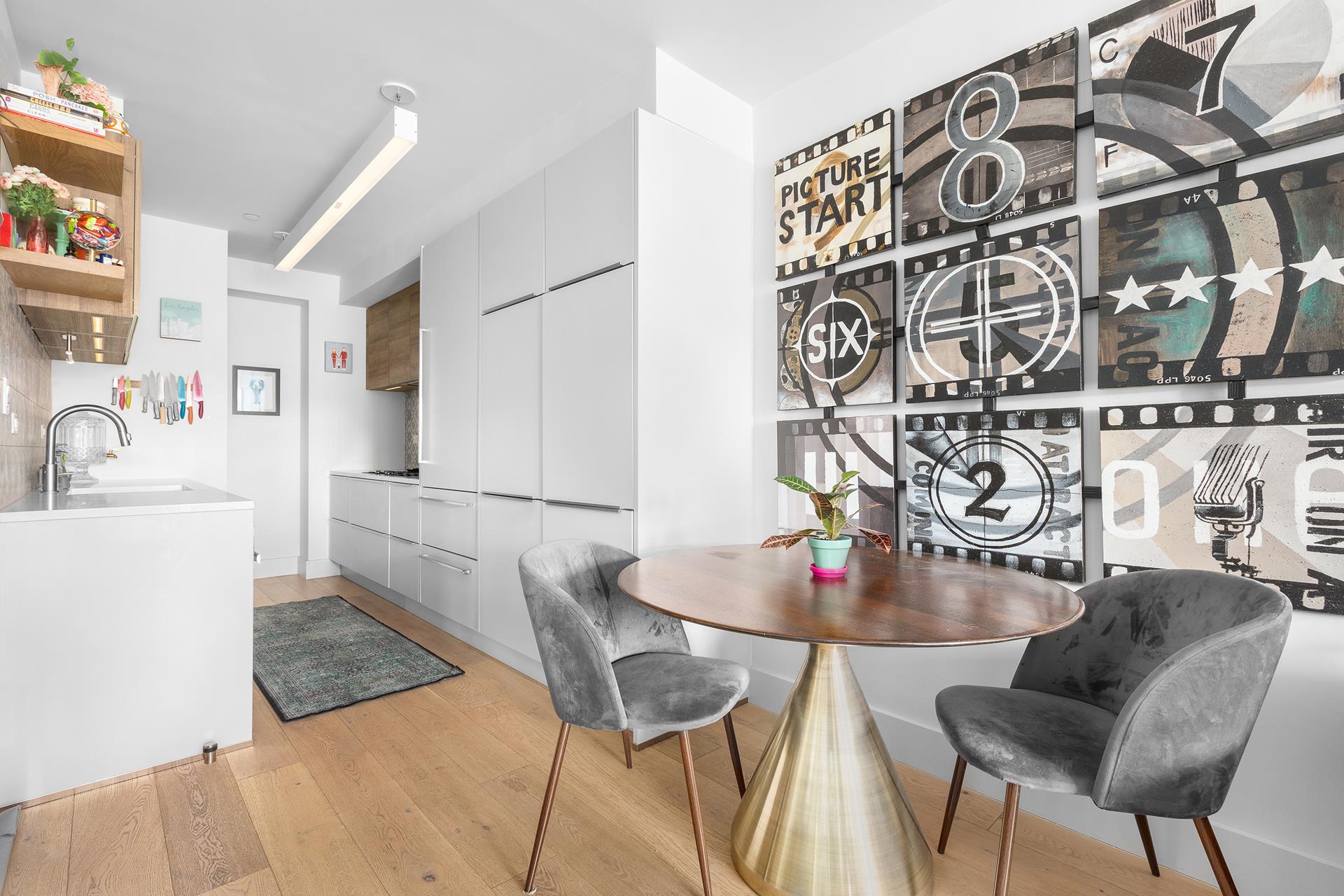 800 Dean Street, Unit PH Brooklyn, NY 11238 - Photo 8 of 11 a kitchen with a table and chairs
