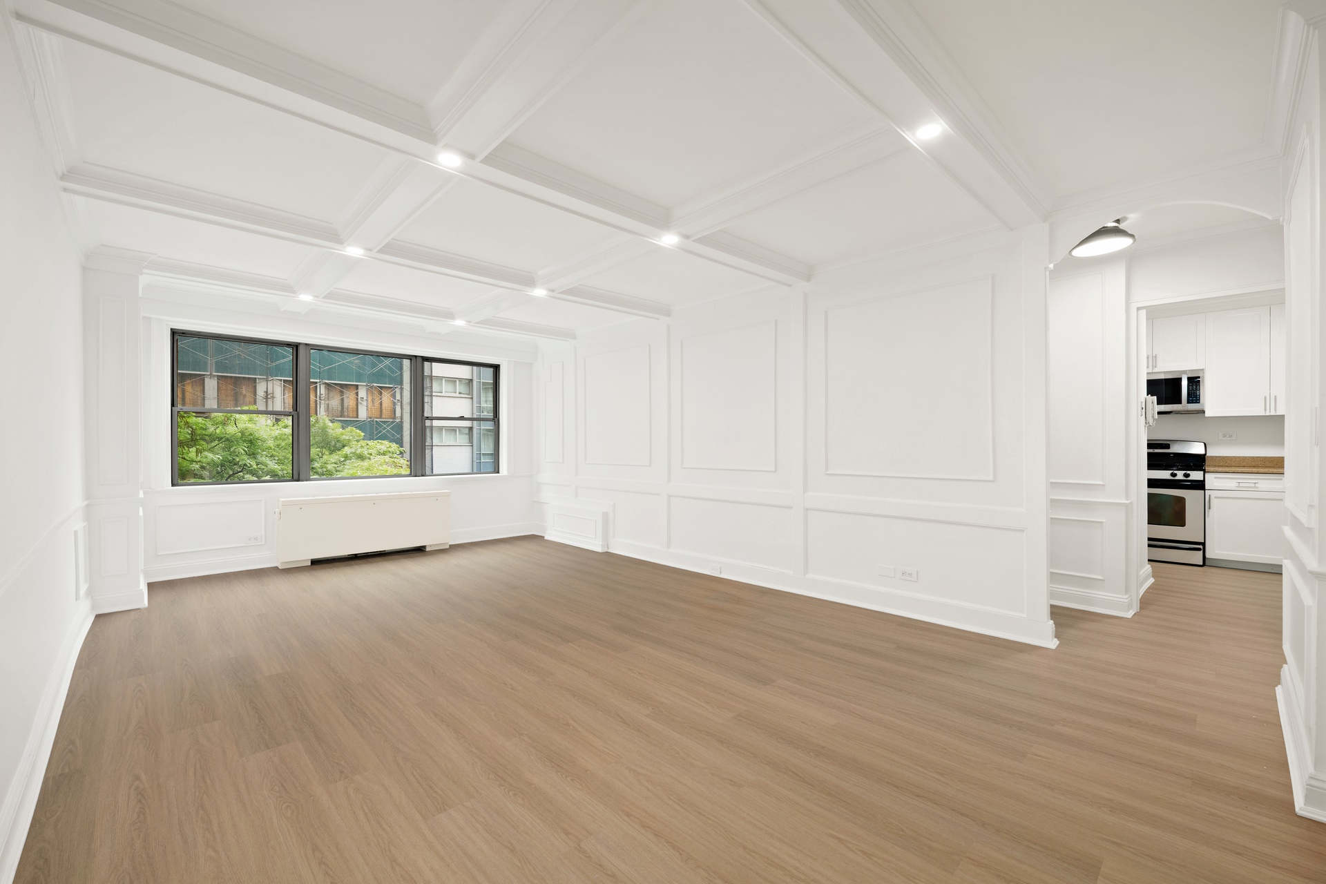 10 West 15th Street, Unit 414 Manhattan, NY 10011 - Photo 2 of 16 a view of an empty room with wooden floor and a window