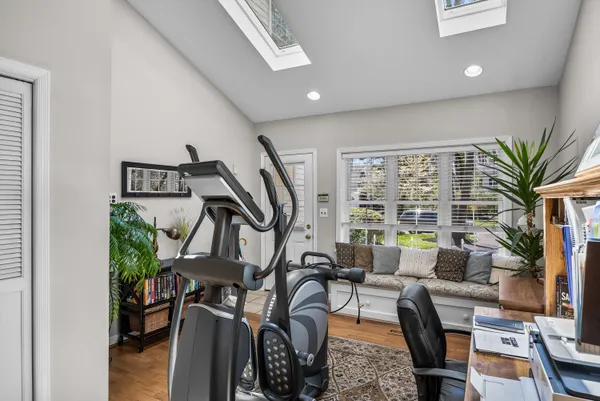a spacious bedroom with a bed and a chandelier